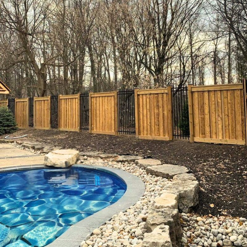 Assorted fence designs featuring iron, chain link, wood, and greenery, demonstrating creative 'Fence Mullet' options for cost-effective and stylish property boundaries.