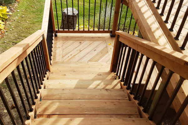 Lifestyle shot down stairs of Nuvo Iron square baluster combo kit.